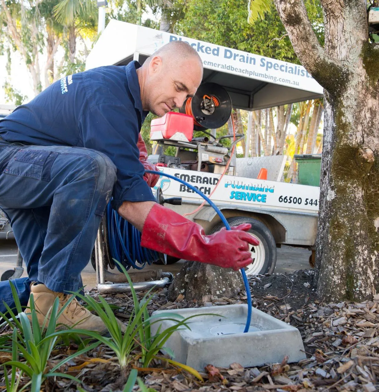 plumber using a tool for clogged drain
